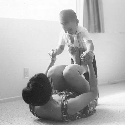 Young Danny playing on the floor with his mother