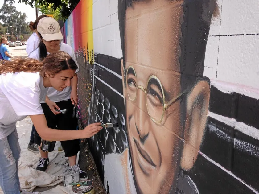 Students in front of a mural